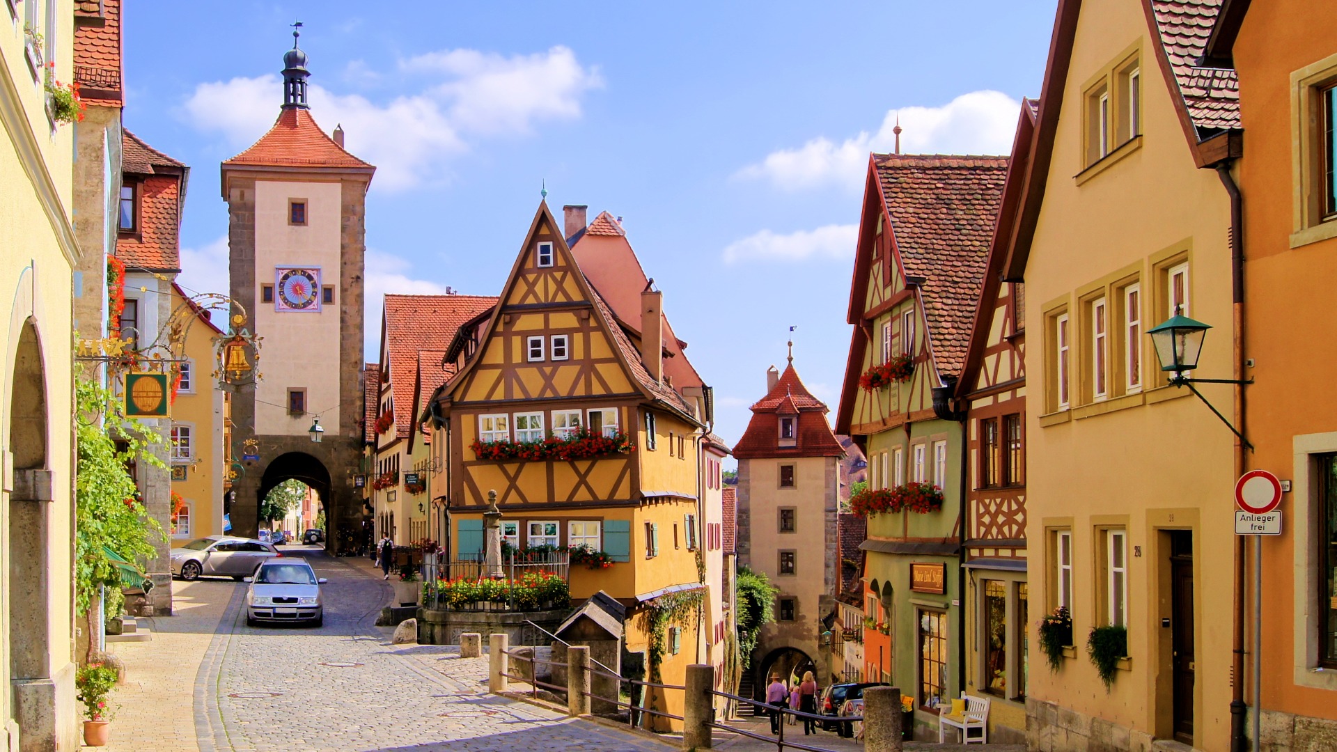 A quaint town with beautiful half-timbered houses of various pastel colors. 