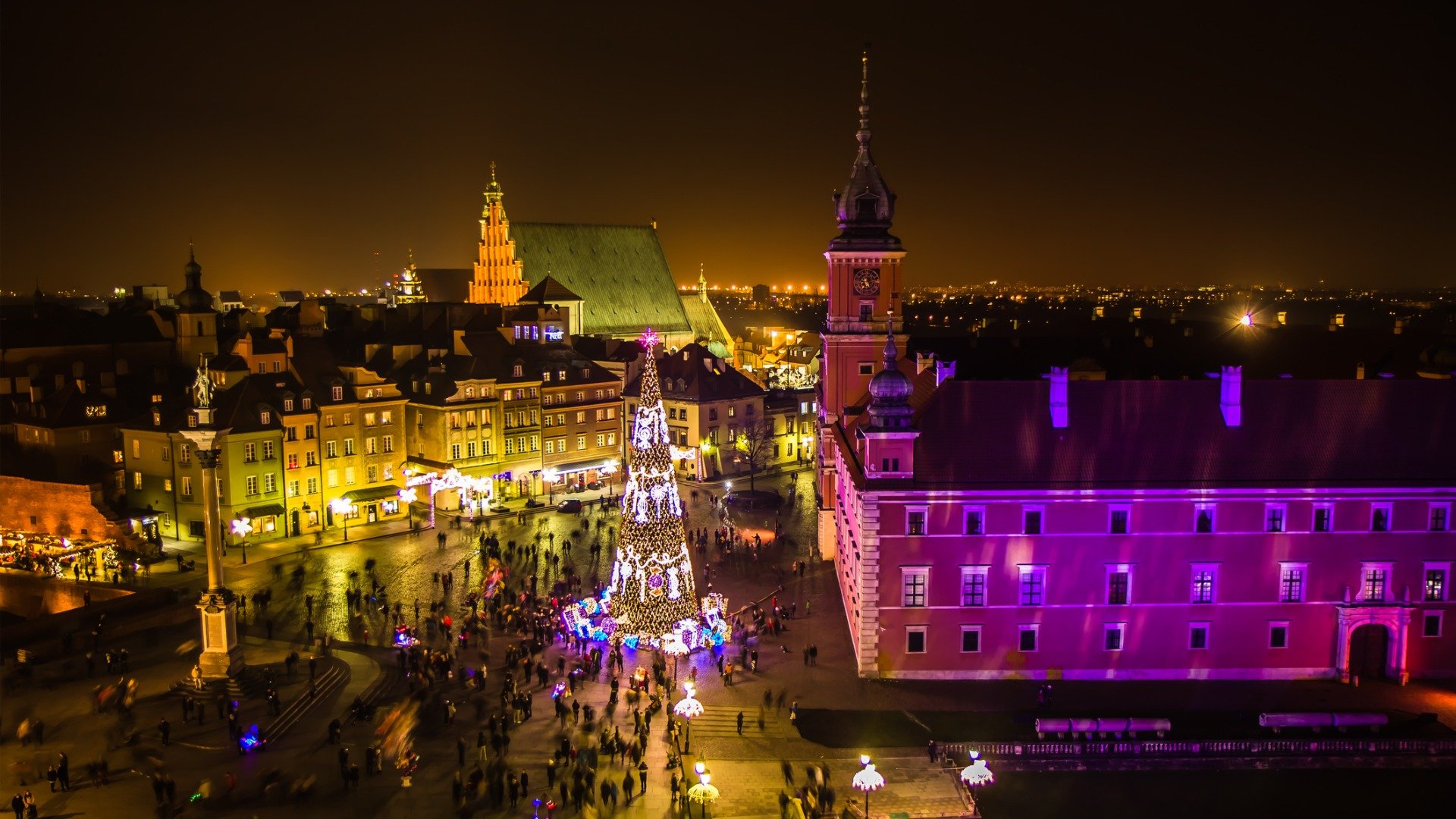 An aerial view of Warsaw at Christmas with a Christmas tree in the heart of the square. 