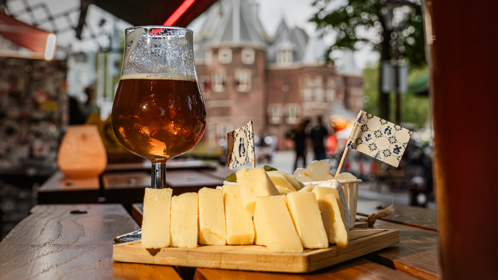 A board of Dutch cheese served with amber beer in Amsterdam.