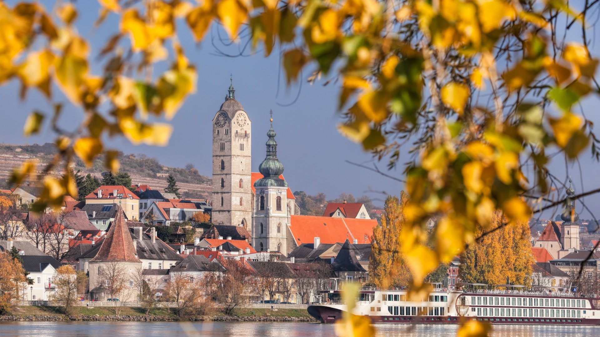 A beautiful town with autumn leaves in the foreground. 