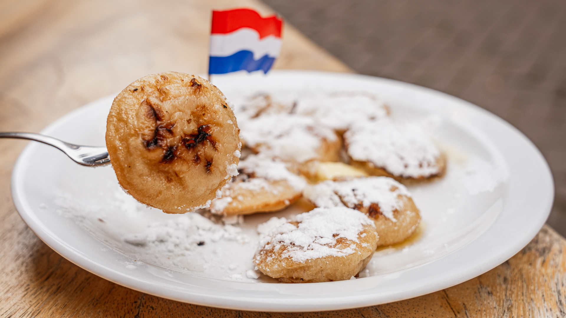 A plate of sugar-covered poffertjes.