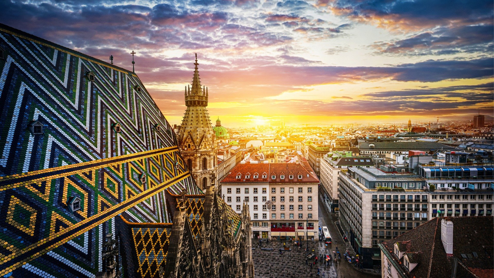 A beautiful sunset over Vienna's skyline with the glistening roof of St Stephen's Cathedral in the foreground. 