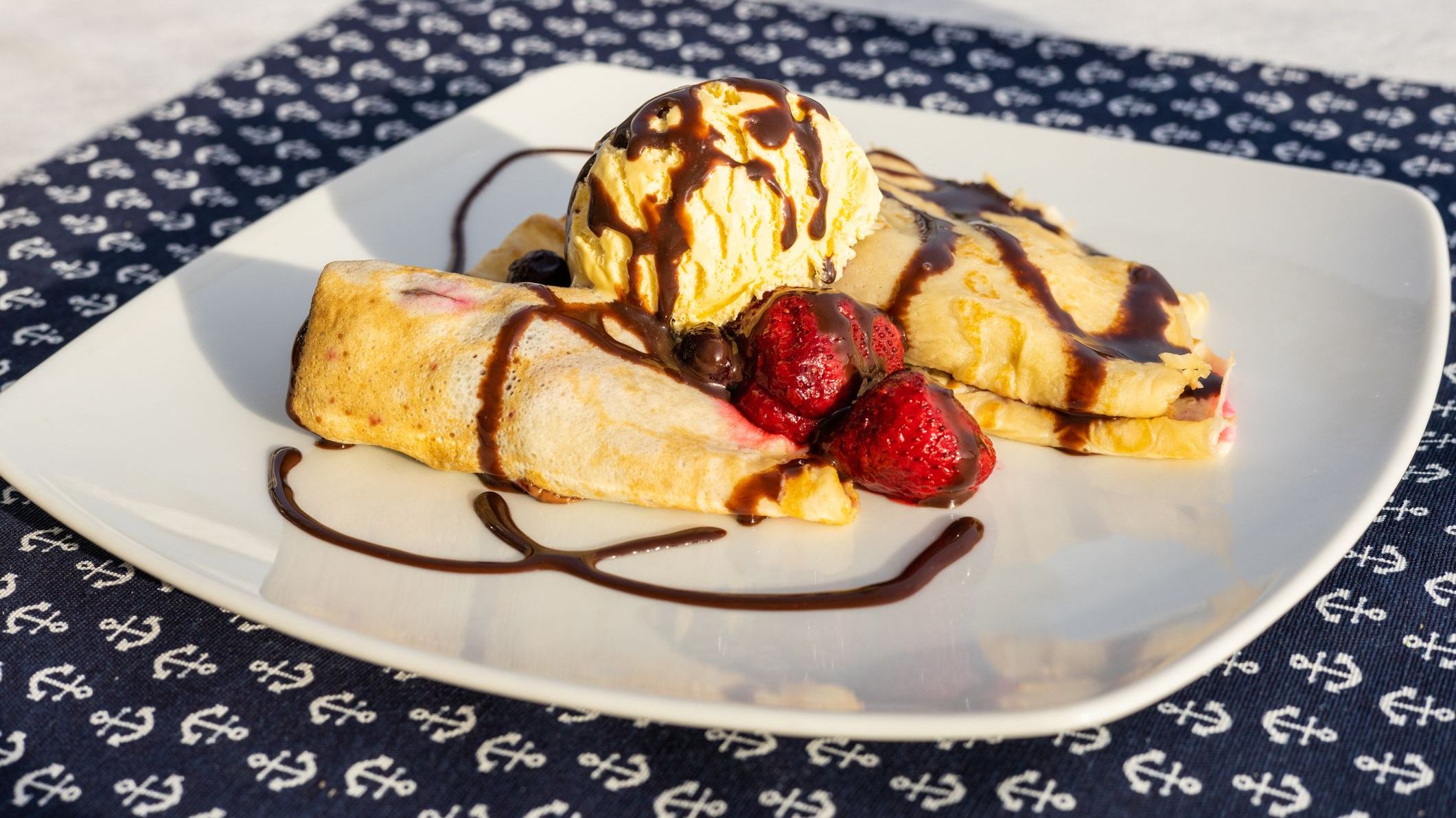 Palacsinta, traditional Hungarian sweet pancakes served with fruit and a scoop of ice cream.