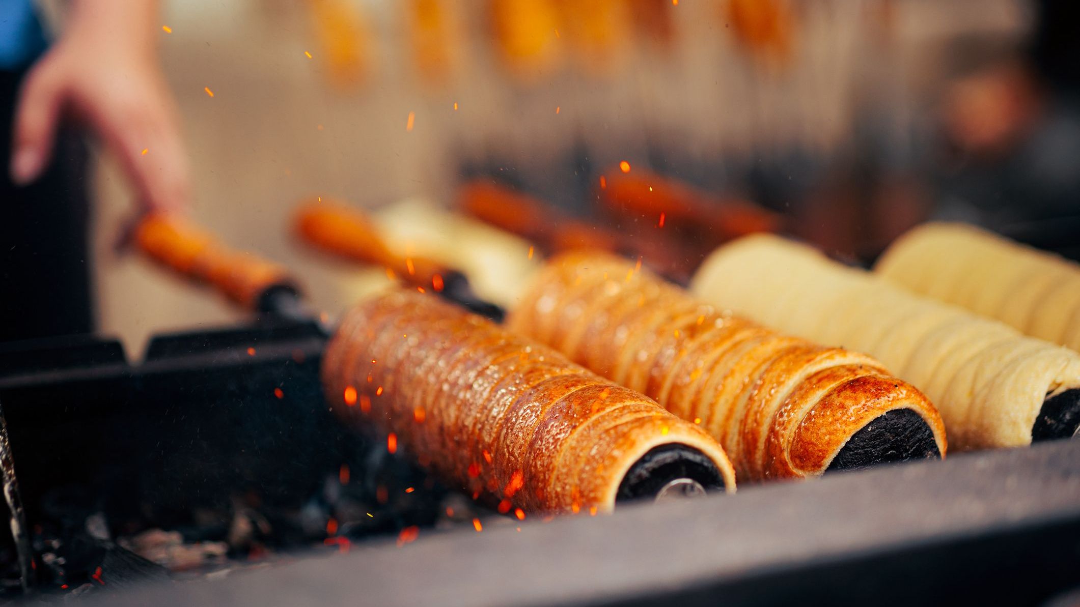Delicious Hungarian Chimney cake being prepared over coals.