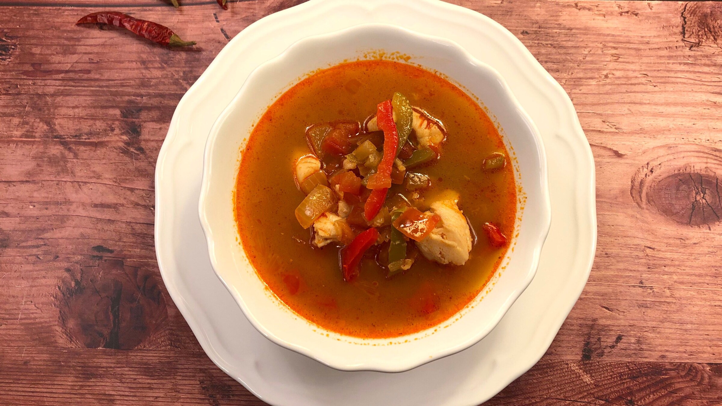 A top-down photo of a fish soup in tomato sauce, the best Hungarian food that's not meat-based.