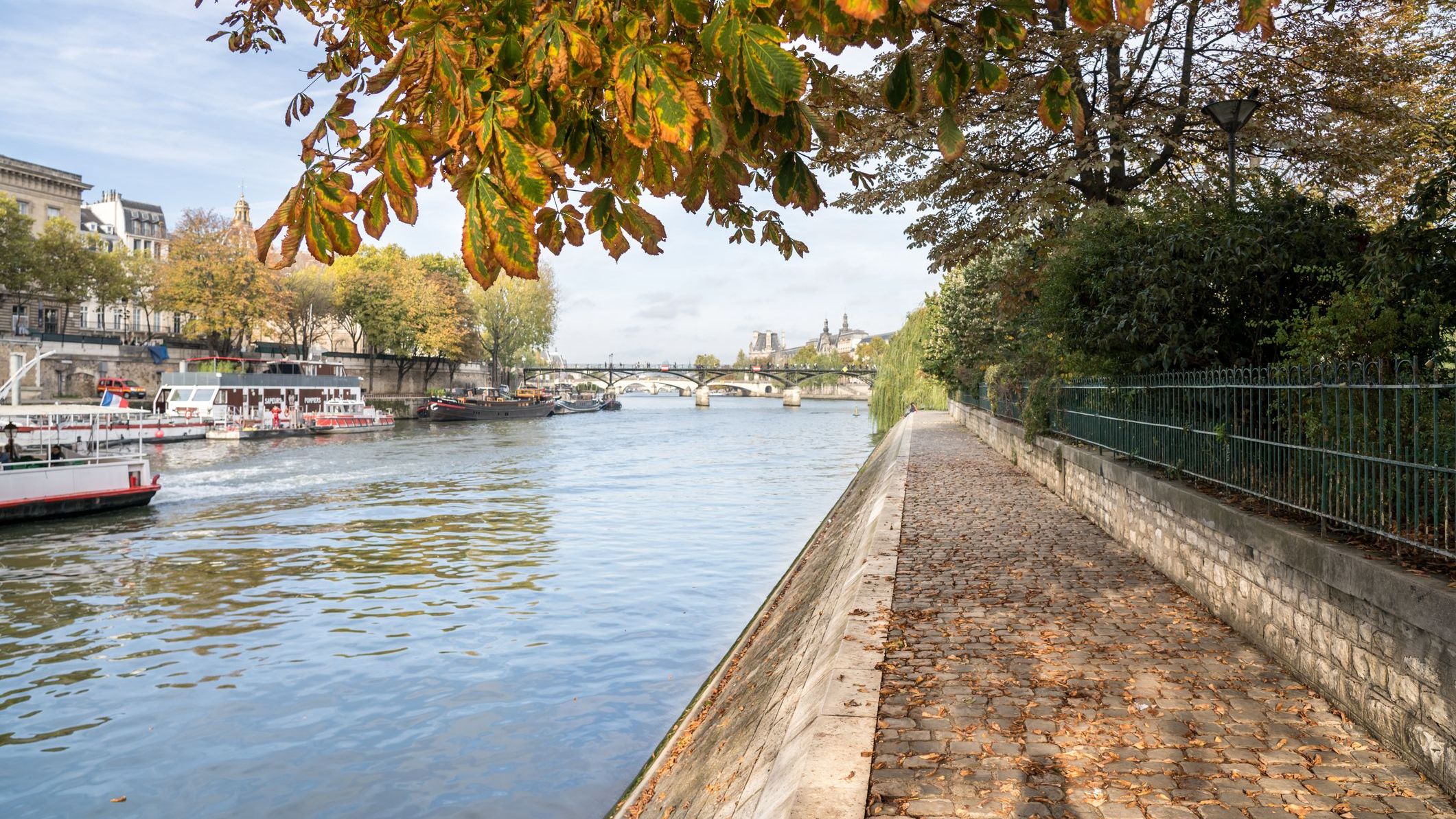 A scenic walkway next to a river. 