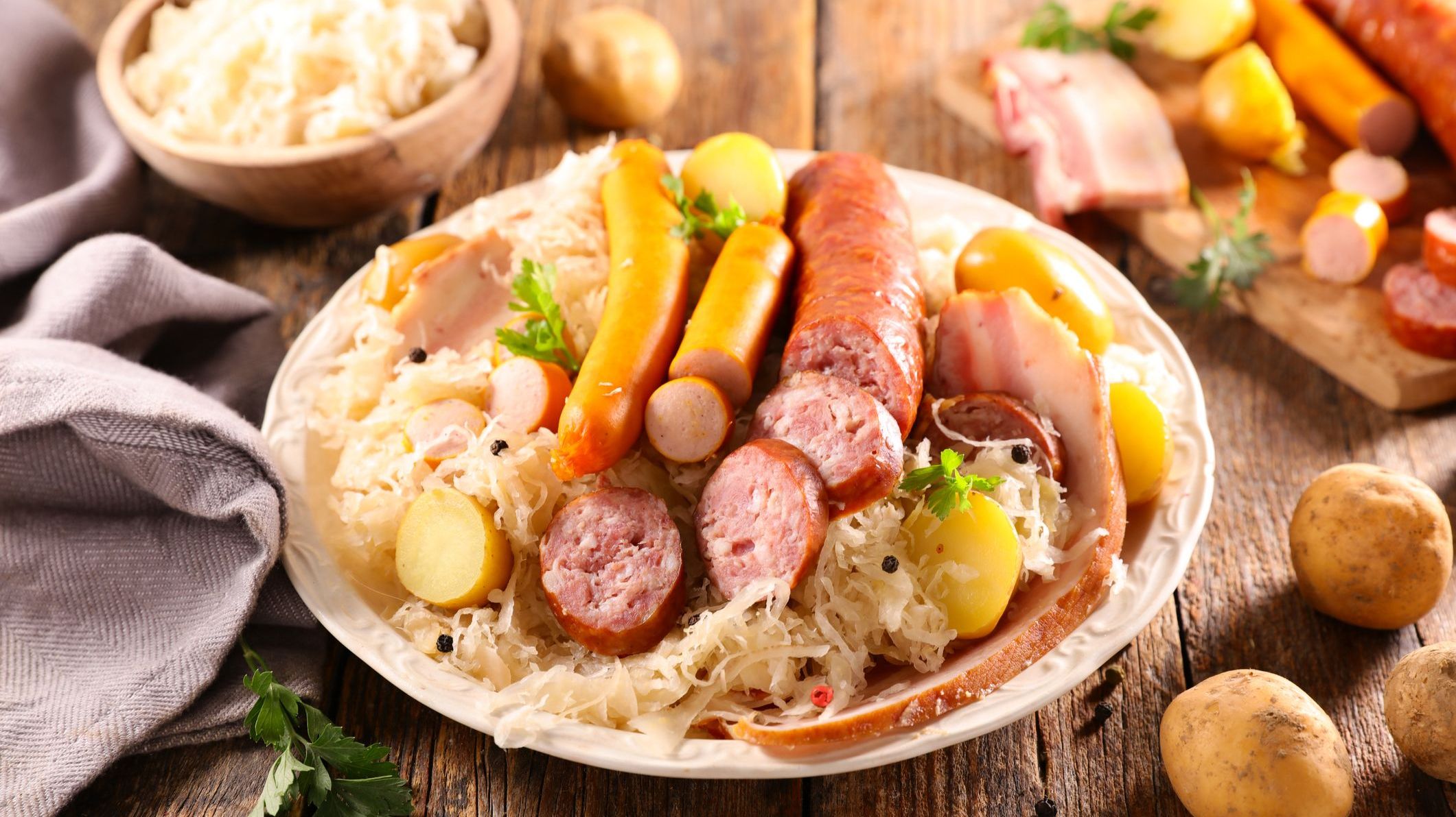 A platter filled with Sauerkraut, sausages and boiled potatoes.