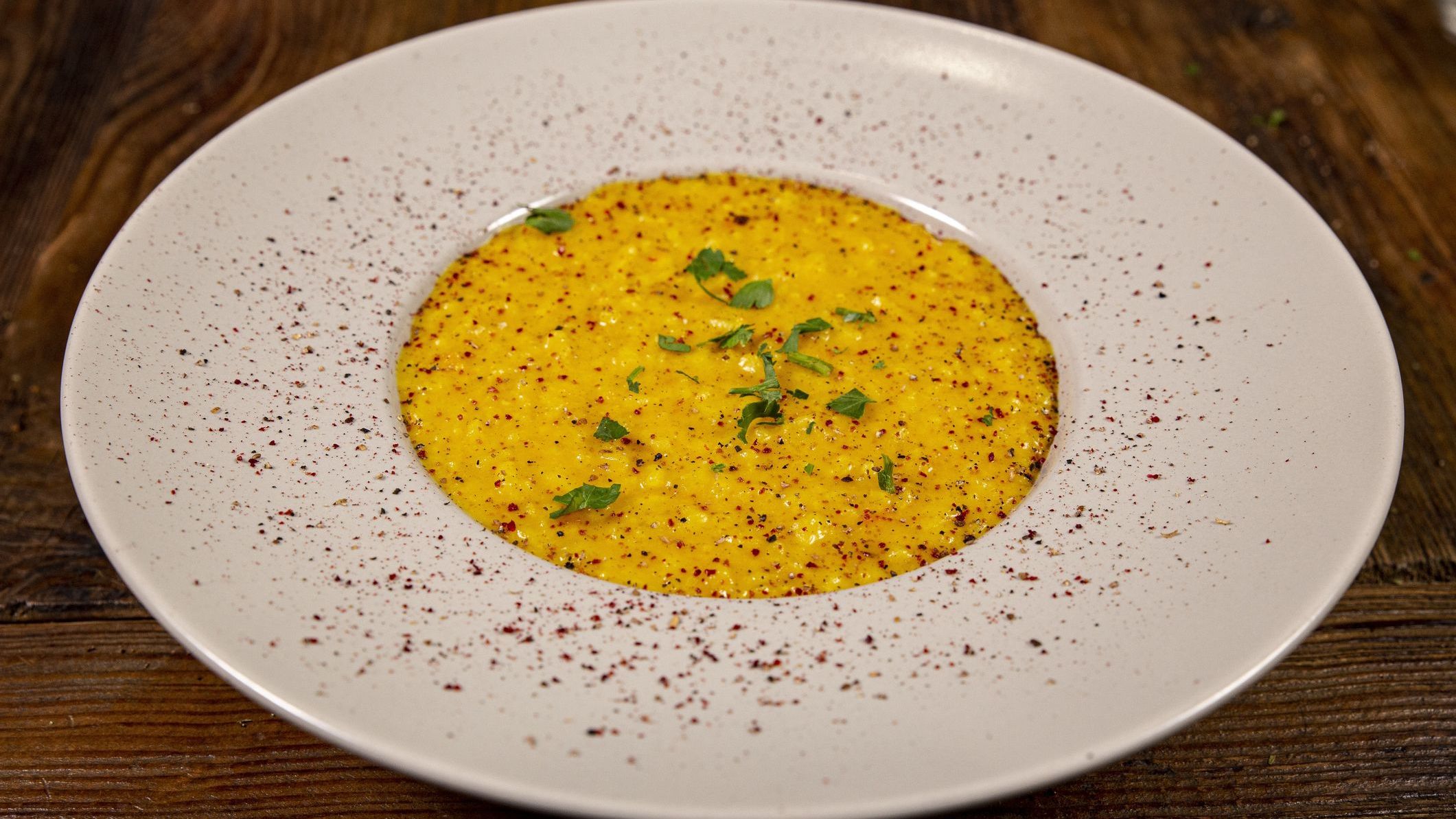 Close up of a plate of risotto with saffron, a staple of the best Swiss food.