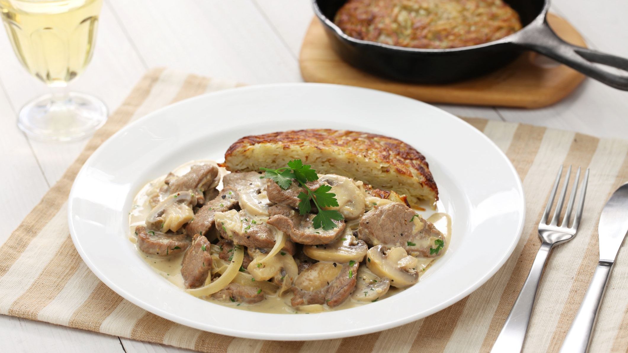 A dish of Zurich-style veal stew served with Rosti potato.