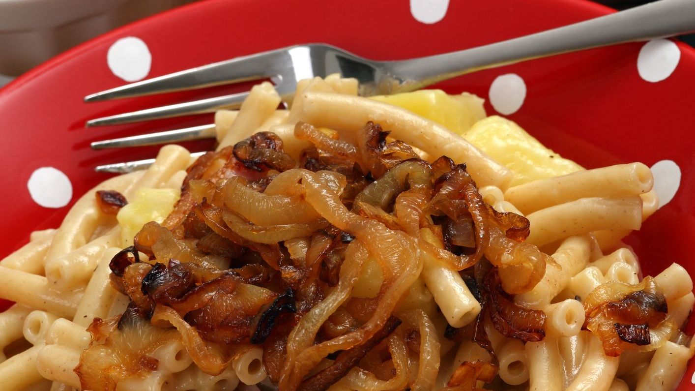 Photo of a bowl of Älplermagronen, or Alpine farmer's macaroni, a traditional Swiss meal made with noodles, potatoes, cheese, onions and served with applesauce. For some, it's the best Swiss food.