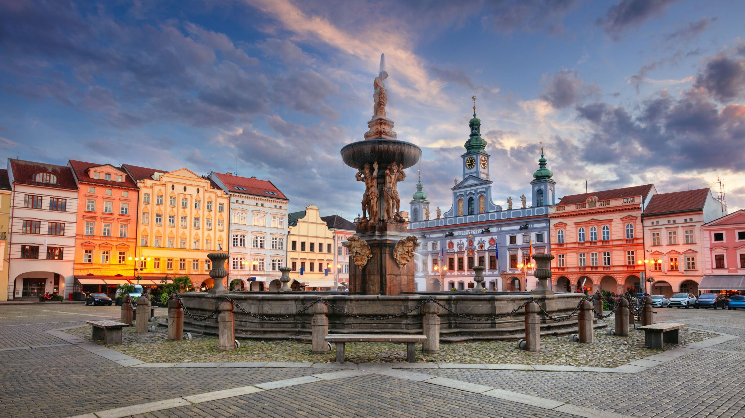 A cityscape image of downtown Ceske Budejovice with Premysl Otakar II Square and Samson Fountain at summer sunset.