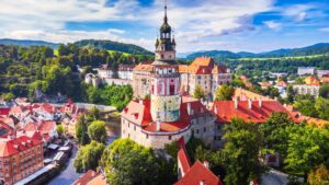 An aerial view over the historic center of Cesky Krumlov and the Vltava River.