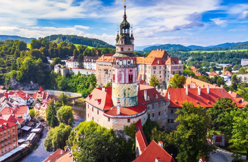 An aerial view over the historic center of Cesky Krumlov and the Vltava River.