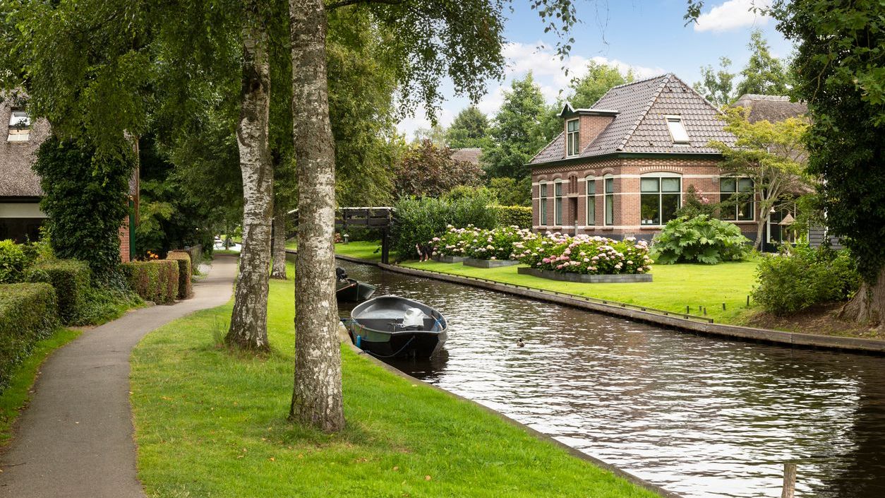 The quaint village of Giethoorn with its picturesque houses on small islands, narrow wooden bridges and beautiful vegetation.