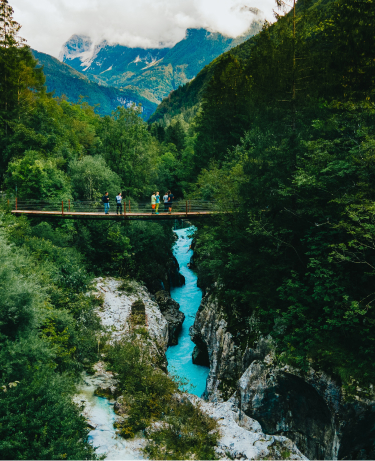 The image captures a moment at the Great Soča Gorge (Velika korita Soče) in the Soča Valley, Slovenia. 