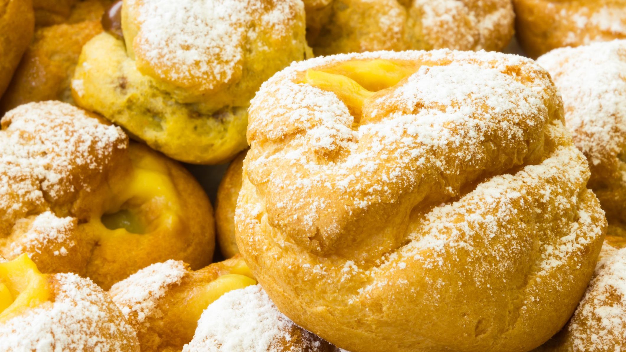 A close-up of puff pastries filled with cream. 