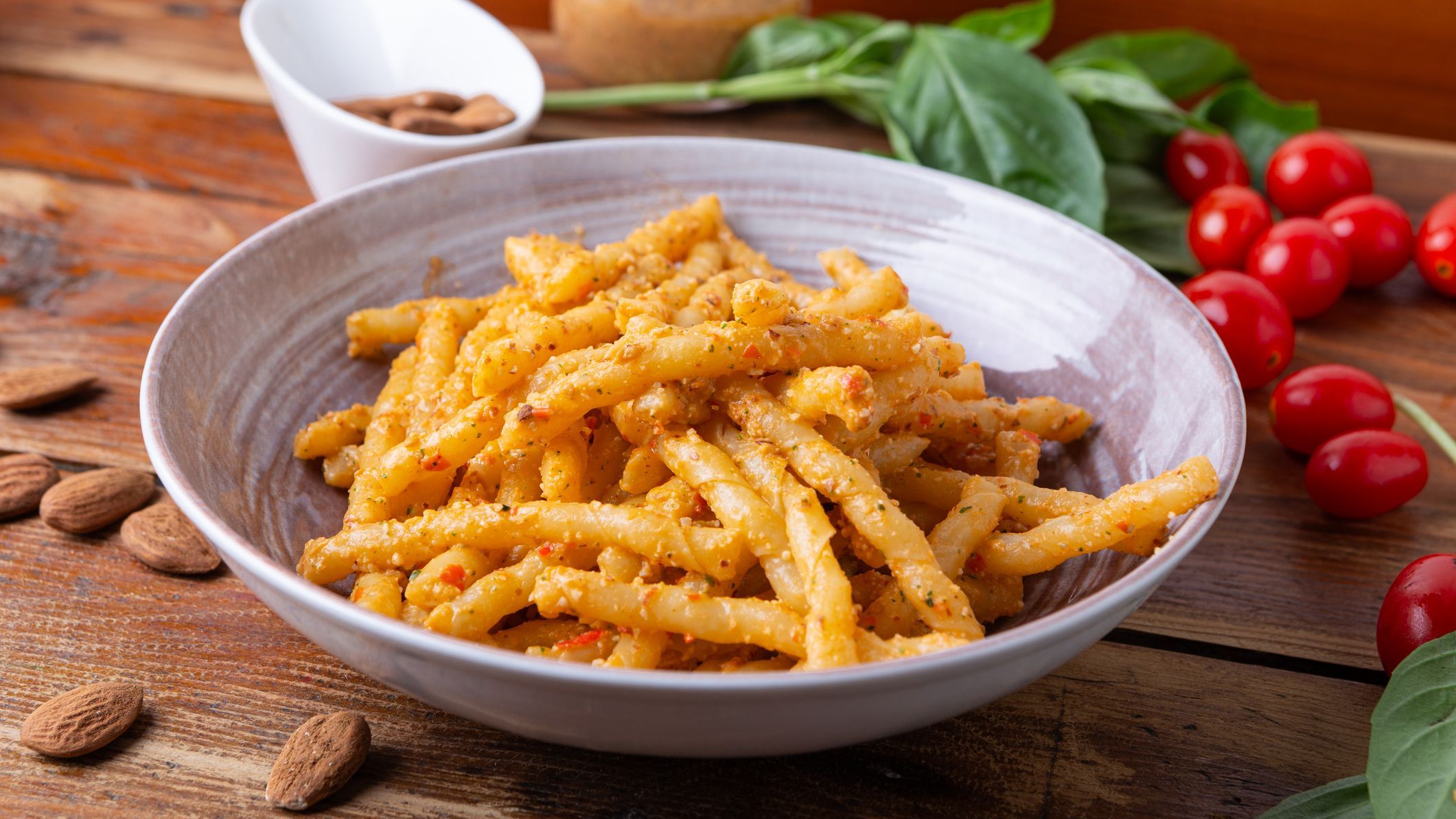 Sicilian pasta with almond and tomato pesto. Typical Italian food from Sicily, pasta with red pesto.