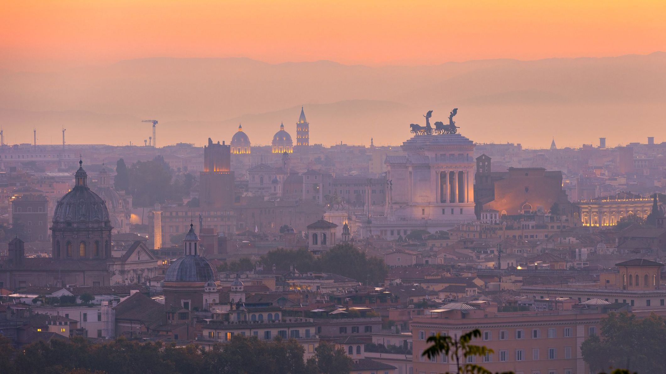 A vibrant sunrise over the city of Rome seen from the Terrazza del Gianicolo and Piazzale Giuseppe Garibaldi.