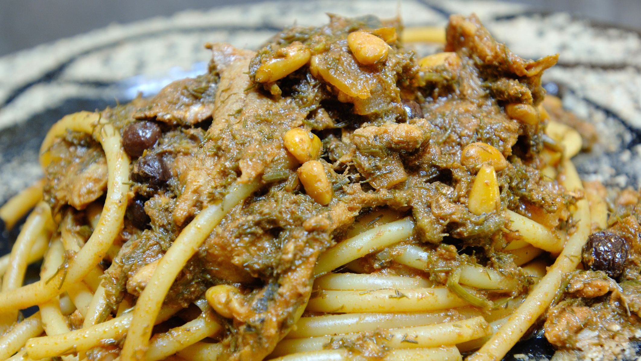 A close-up of pasta with sardines or pasta con le sarde, a typical dish of the best food in Sicily. 