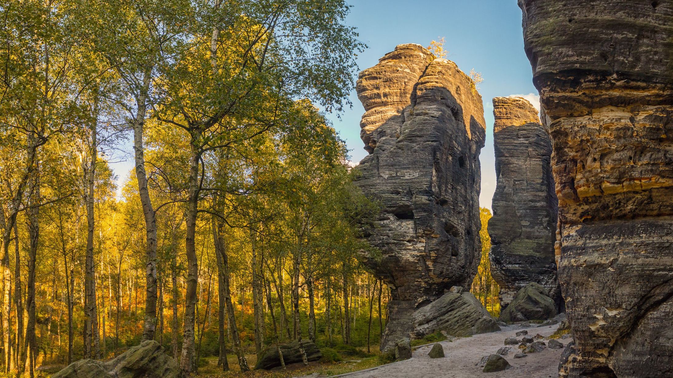 Impressive rock formations among trees in the Sandstone Mountains.