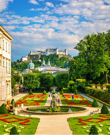 Beautiful view of famous Mirabell Gardens with the old historic Fortress Hohensalzburg in the background in Salzburg, Austria. Famous Mirabell Gardens with historic Fortress in Salzburg, Austria.