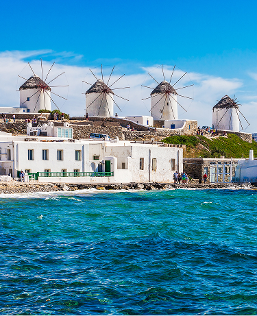 Two of the famous windmills in Mykonos, Greece during a clear and bright summer sunny day