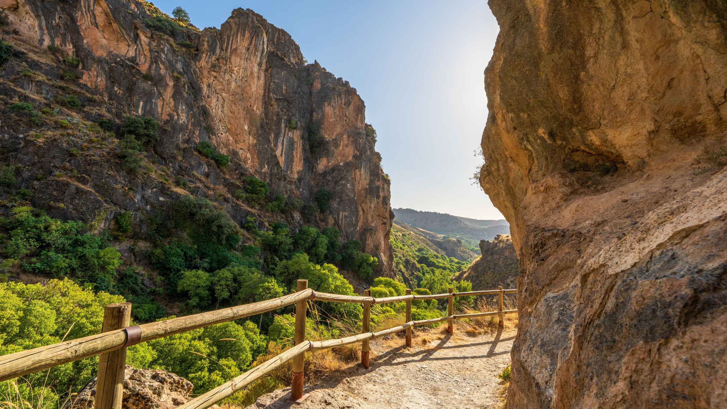 A hiking path among dramatic rocks on a sunny day.