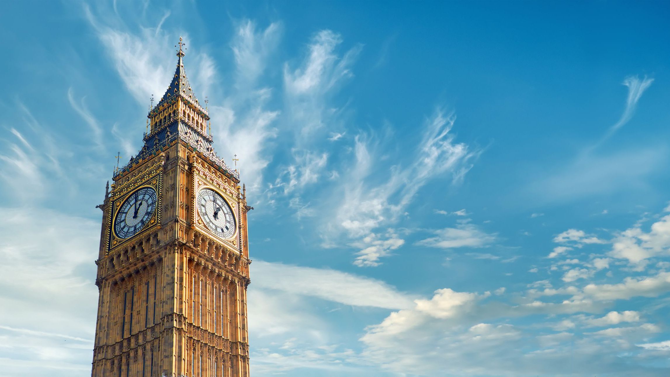 The Big Ben Clock Tower in London, UK, on a bright day.