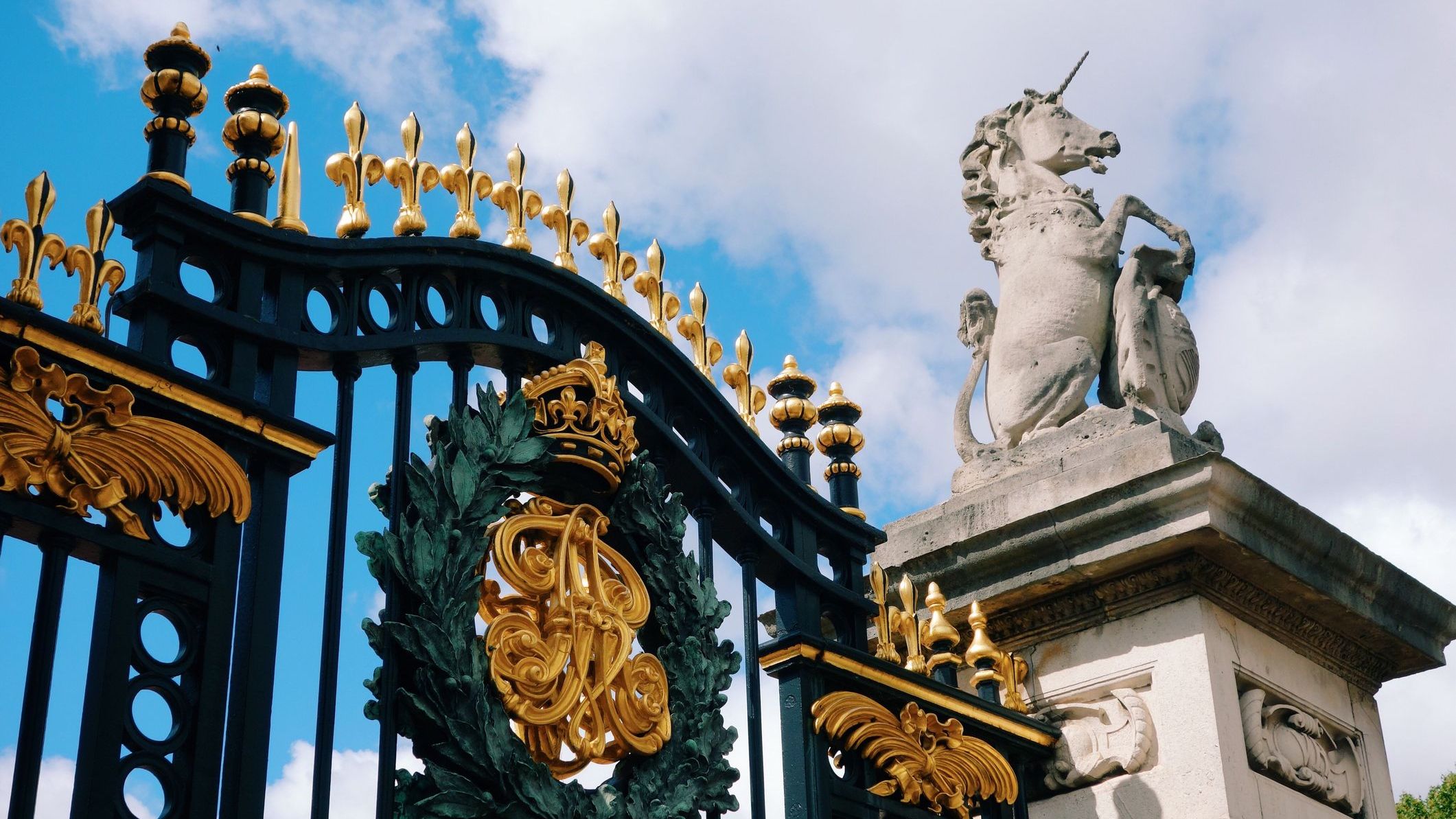 Low-angle view of the entrance gate against the sky at Buckingham Palace, one of the best places to visit if you're wondering what to do in London.