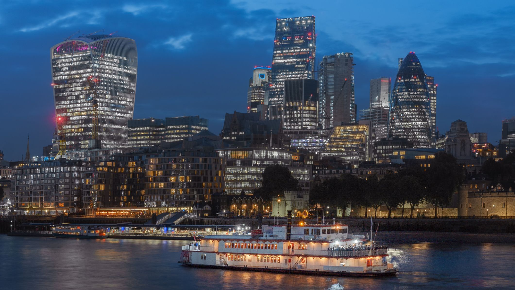 Thames Embankment and London skyscrapers in the City of London at night.