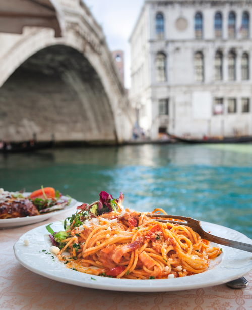 Traditional Italian pasta served with rich tomato sauce, parmesan cheese, and fresh basil.